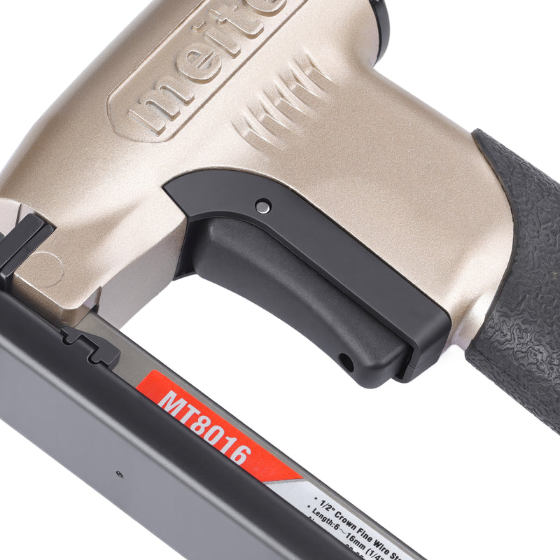 Close-up of the trigger section of the meite USA MT8016 21Ga 1/2'' crown pneumatic upholstery stapler.
