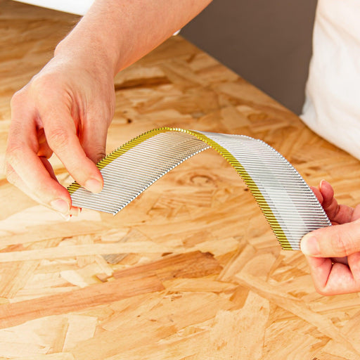 Flexible strips of Meite USA 15 gauge DA-style angled finish nails with tape collation for smooth nailer feeding