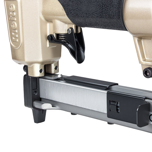 Close-up of the Meite USA 425KC 18Ga  pneumatic upholstery stapler showing the magazine loaded with 1/4'' crown staples and the trigger section.