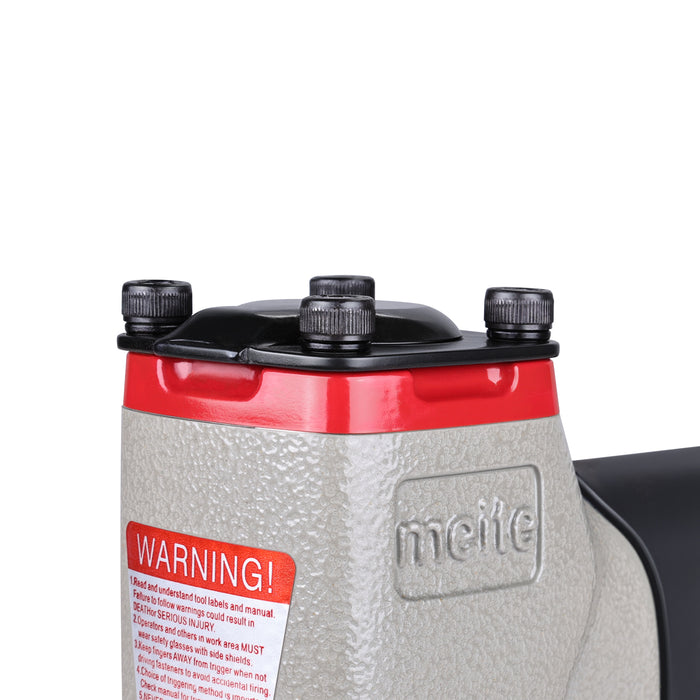 Close-up of the top housing of the meite USA 7116B 22 gauge pneumatic upholstery stapler, showing the exhaust outlet, and warning label.