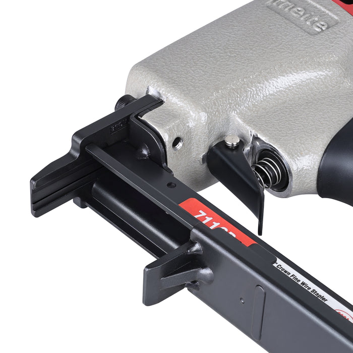 Open-nose view of the meite USA 7116B pneumatic upholstery stapler, showing the internal magazine track and staple-loading channel.