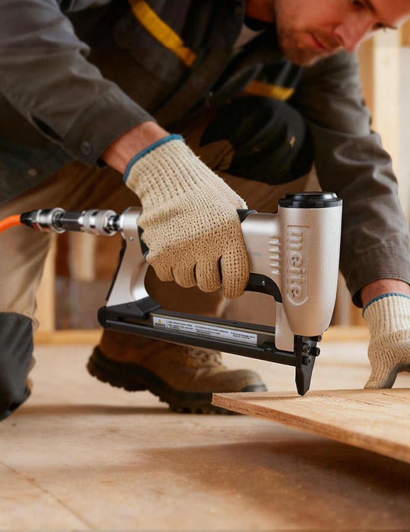 Meite USA pneumatic stapler on wood during construction, showcasing professional woodworking and fastening tools.